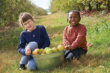 Kids after picking apples at the orchard