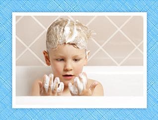 boy in bath with soapy hands
