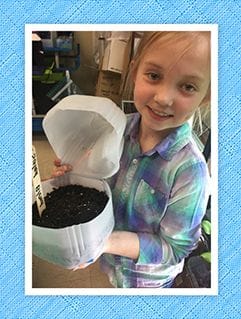 girl growing a plant indoors