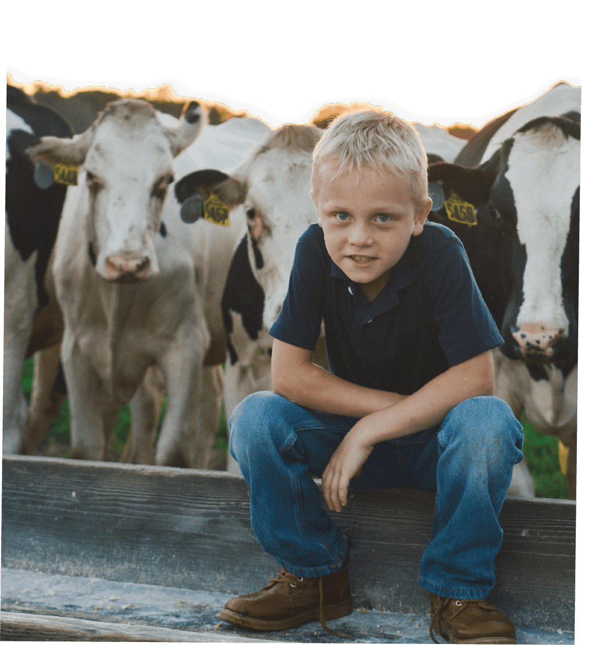 Kid Sitting in Farm Trough