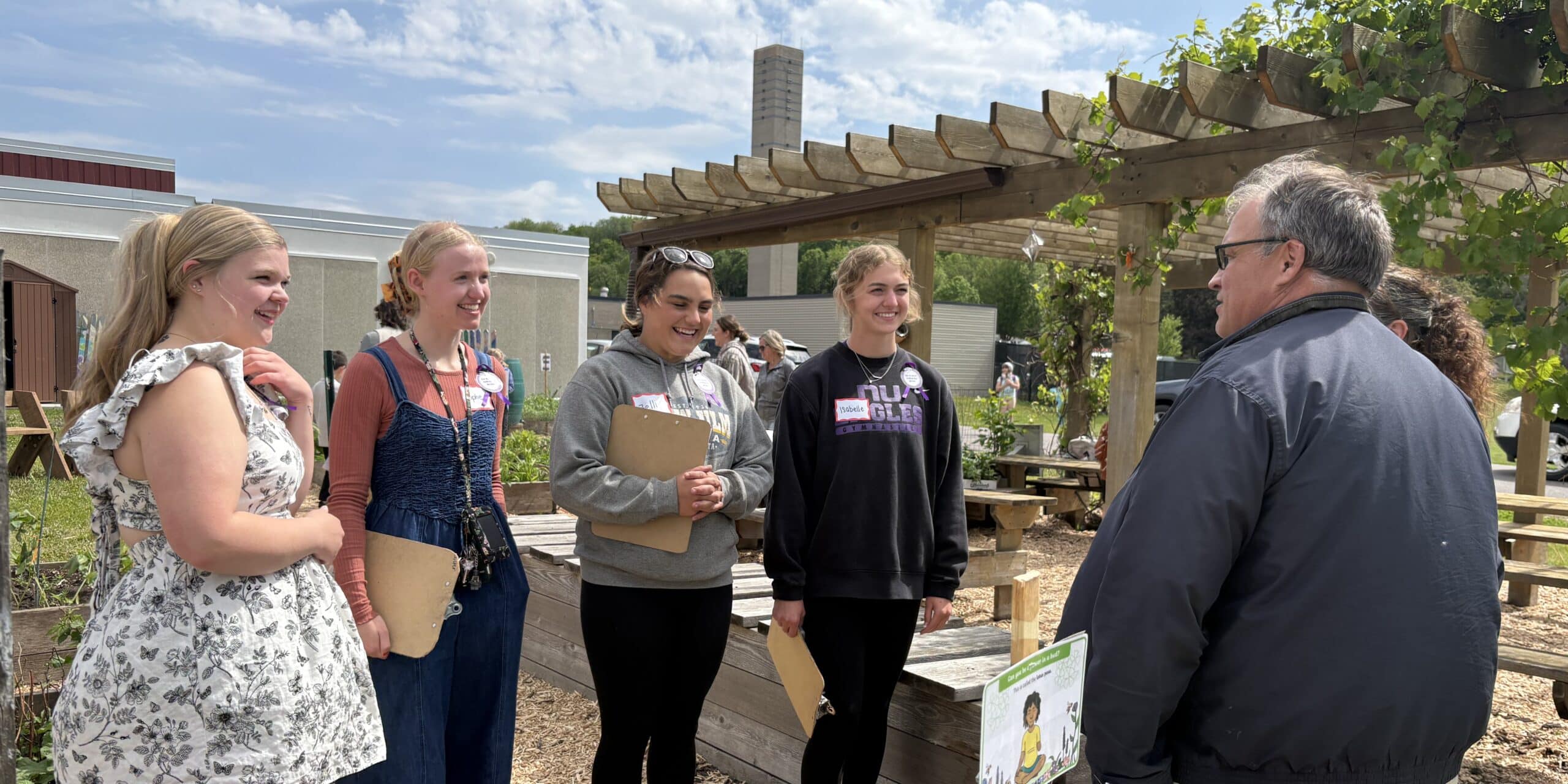Four high school students speaking to the Commissioner